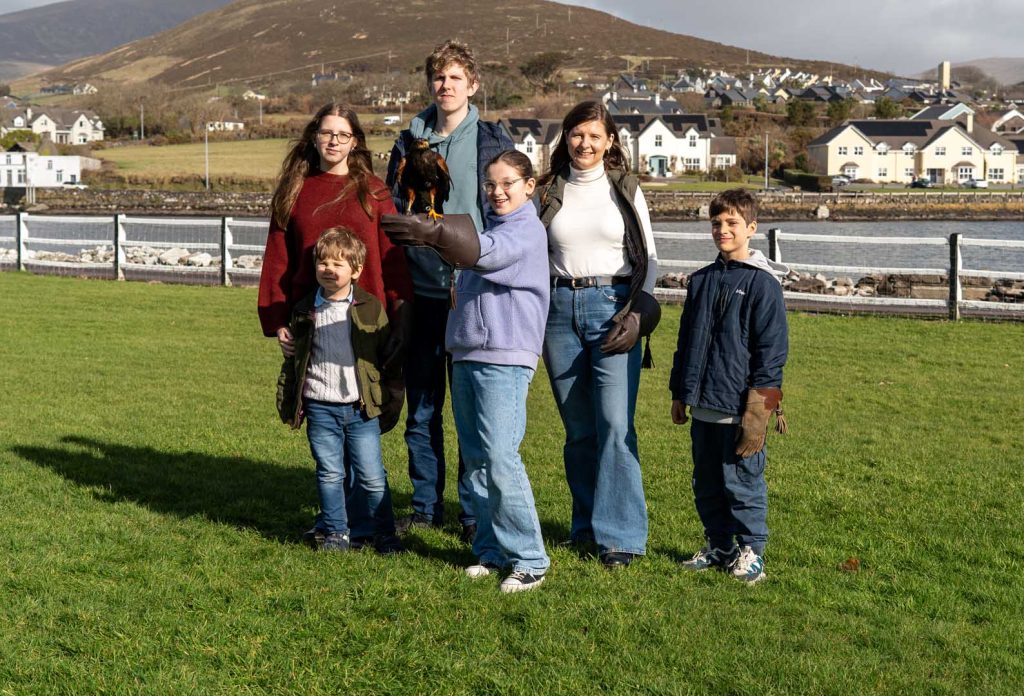 A happy family posing with a falcon