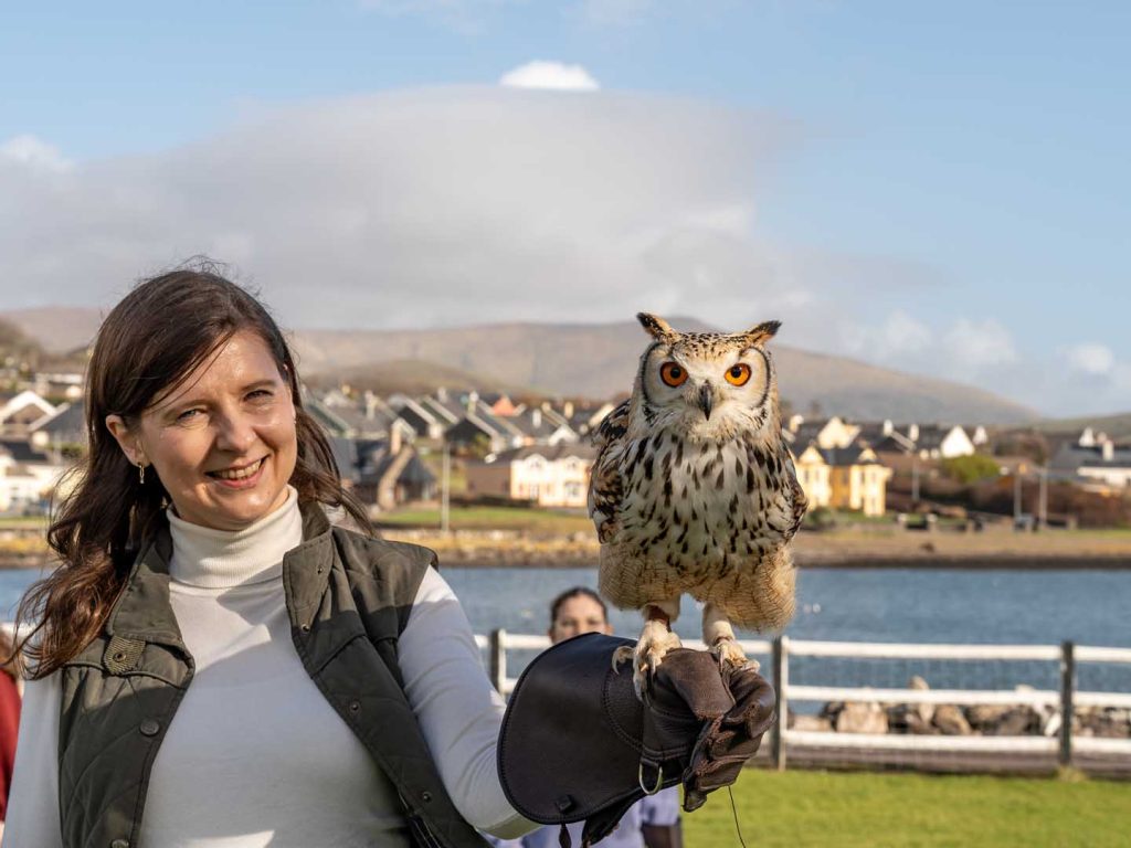A woman holding an owl