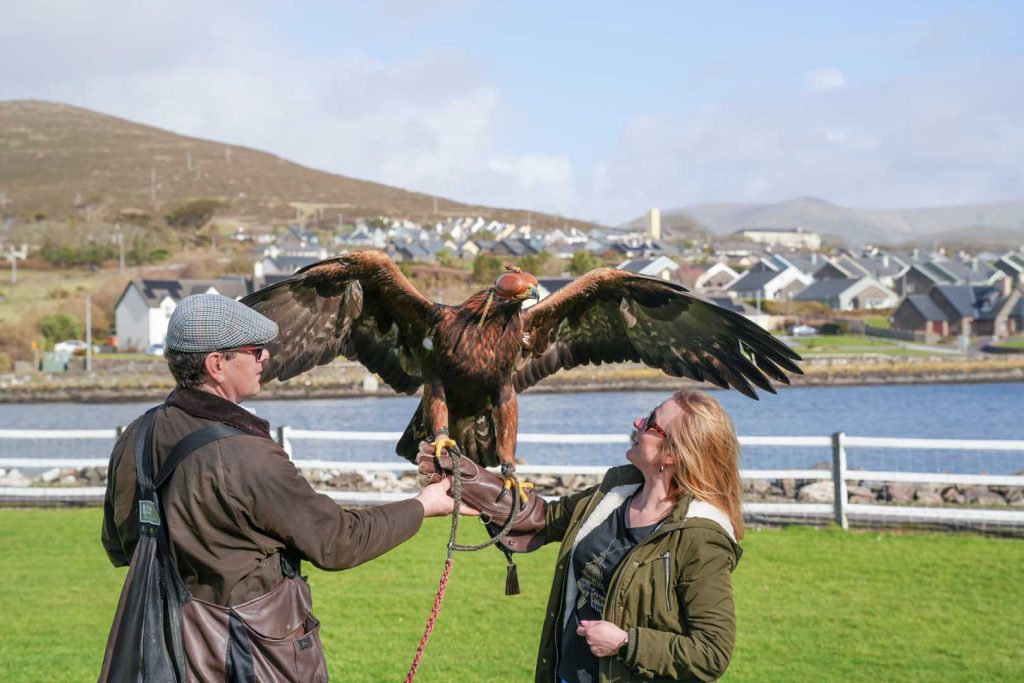 A man and a woman holding a bird