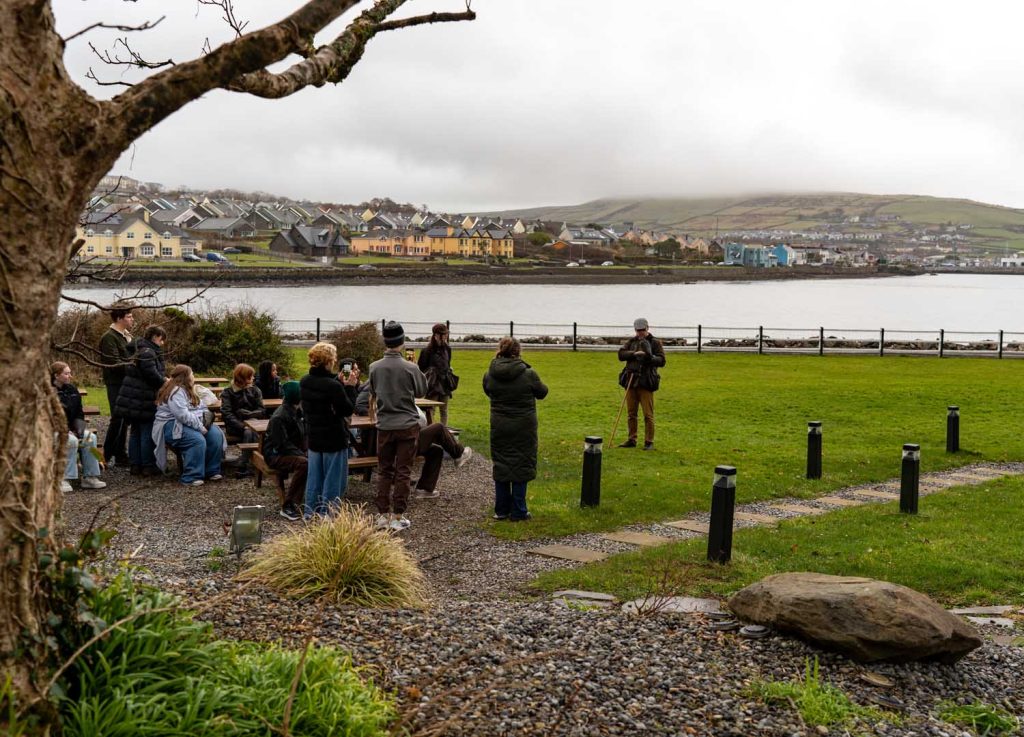 A group sitting on picnic benches before a demonstration