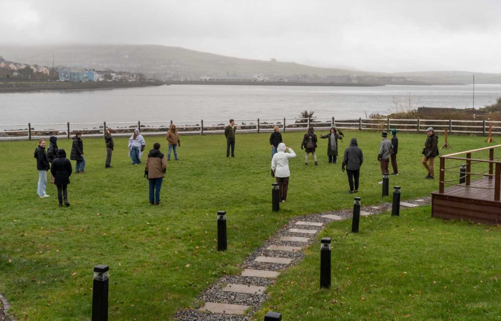 A group enjoying a demonstration overlooking the bay